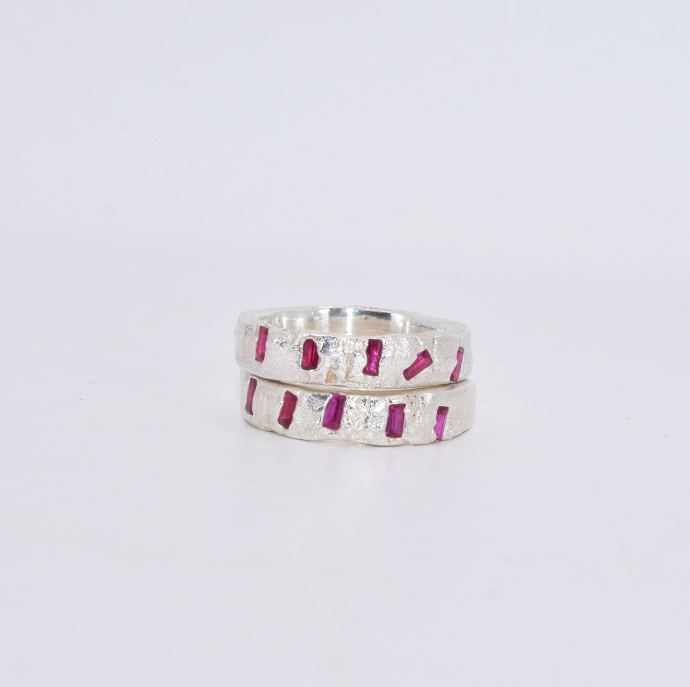 two versions of silver bands with 5 ruby baguettes placed across the front